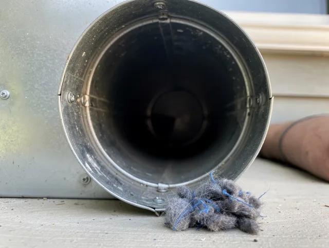 Fort Myers Dryer Vent Cleaning technician using specialized equipment to clear severe dryer vent blockage in Fort Myers